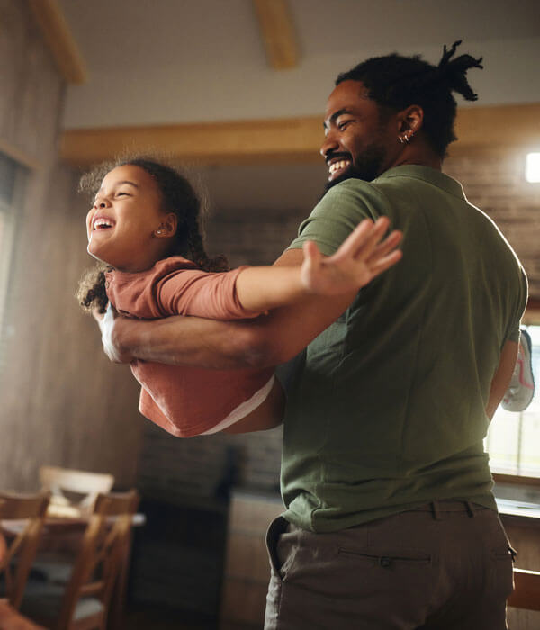 father swings his daughter around in his arms