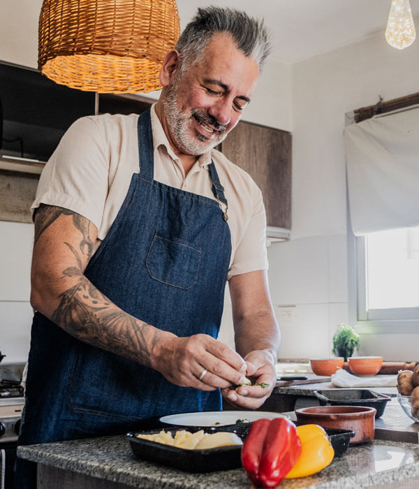 older man prepares fresh produce for a meal